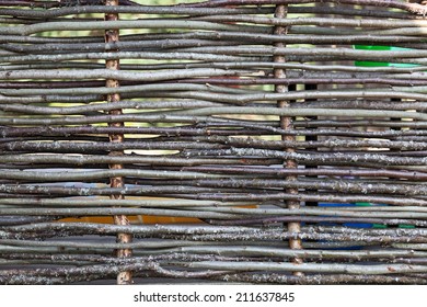 Background of rustic fence from small tree stems