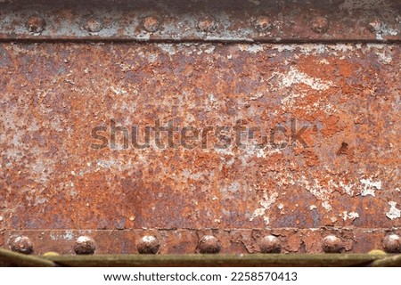Background with rusty metal beams and powerful rivets. Old bridge mounts.