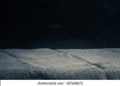 Background With Sack Cloth On Wooden Deck Table And Dark Grunge Background