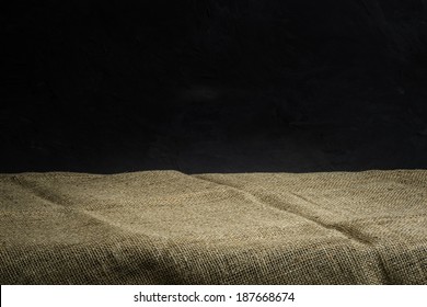 Background With Sack Cloth On Wooden Deck Table And Dark Grunge Background