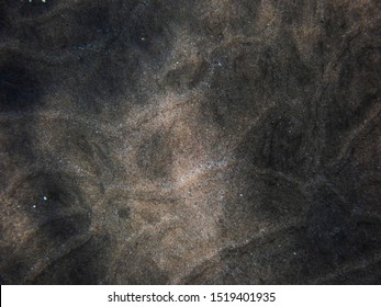 Background Of Sand In Mix Of Dark And Light Underwater Ocean Floor In Hawaii.