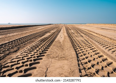 Background with sand and tire tracks towards the sea at Scheveningen in the Netherlands
