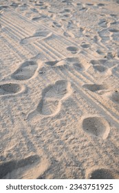 The background of a sandy beach with footprints. Sand beach background