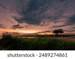 The background of the sea by the evening sea, with natural beauty (sea water, rocks, sky) and fishermen are fishing by the river bank, is a pleasure during travel.