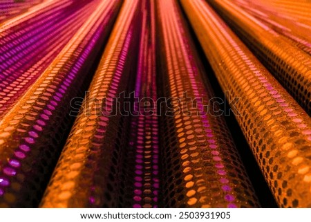 Background of Selective focus close up orange fabric. patterned material with reflective texture. color backdrop with perspective diagonal lines forming a geometric pattern. sstkbackgrounds flyer card