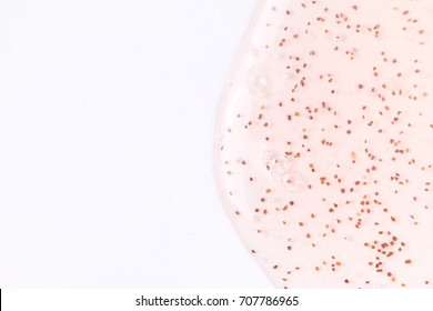 Background of shampoo containing red plastic microbeads