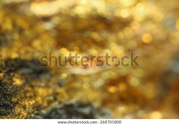 Background with shiny yellow\
gold ore