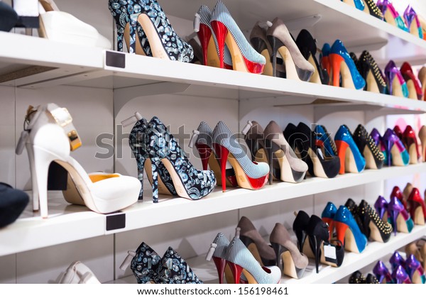 Background with shoes on\
shelves of shop