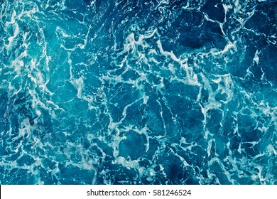 Background shot of aqua sea water surface - Shutterstock ID 581246524