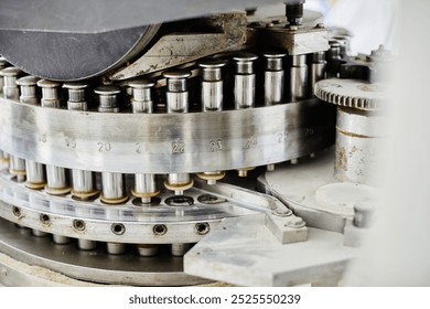 Background shot of punch tools in tablet press machine compressing powder into pills at pharmaceutical manufacturing plant, copy space