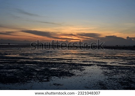 Background Silhouette Evening Sunset of the muddy sea in Thailand