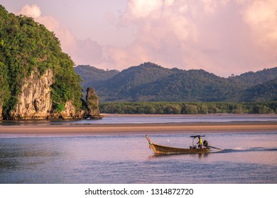 The background of a small fishing boat that is about to dock and there is a blur of water flowing through, being a coexistence of people and nature.