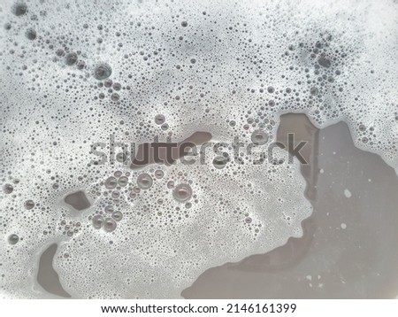Background soap suds (foam) and bubbles from detergent. 