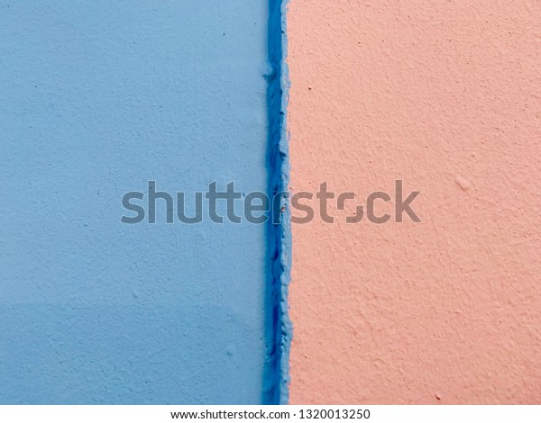 Background, solid colors light blue and salmon\
pink painted on a wall.  Color blocking.\
