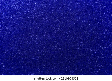 Background with sparkles. Backdrop with glitter. Shiny textured surface. Very dark blue. Mixed neon light Foto stock