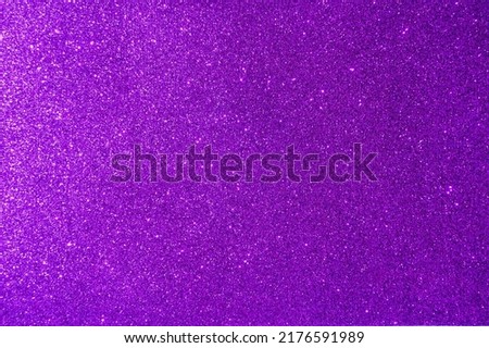 Background with sparkles. Backdrop with glitter. Shiny textured surface. Strong violet. Mixed neon light