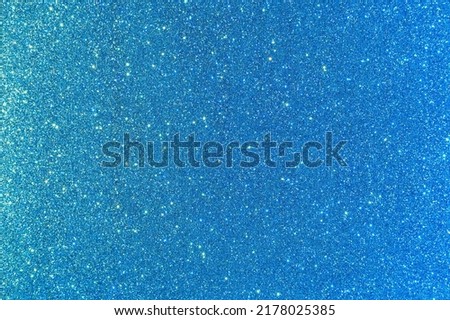 Background with sparkles. Backdrop with glitter. Shiny textured surface. Strong blue. Mixed neon light