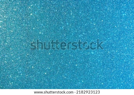 Background with sparkles. Backdrop with glitter. Shiny textured surface. Dark cyan. Mixed neon light