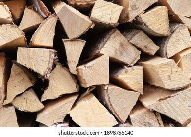 Background From Stack Of Firewood From Birch Tree, For Heating House, Stacked In Backyard, Uncut Wood, Birch. Concept Eco-friendly Home Heating During Cold Season. Overall Plan. Horizontal Format.