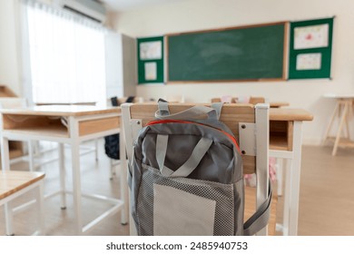 Background of study table and chairs with backpacks in empty classroom. A teaching education classroom without students during back to school in academic elementary kindergarten. - Powered by Shutterstock