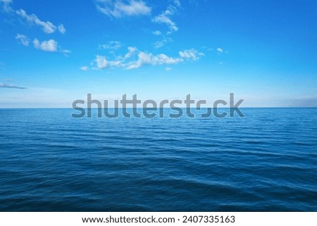 background for summer vacation concept. Nature of the beach and sea, summer with sunlight, sandy beach The sparkling sea water contrasts with the blue sky 