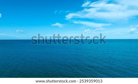 background for summer vacation concept. Nature of the beach and sea, summer with sunlight, sandy beach The sparkling sea water contrasts with the blue sky 