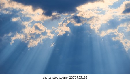 The background of sun rays over clouds. The sun rays break over the clouds.