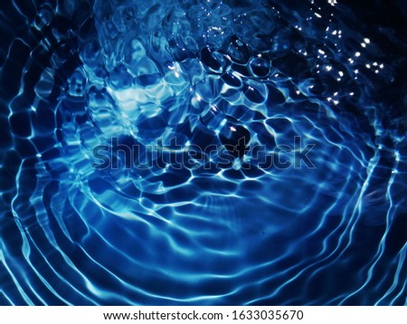 The​ abstract​s of​ surface​ blue​ water​ reflected​ with​ sunlight​ for​ background. Reflection​ on​ the​ surface blue​ water​ for​ background​