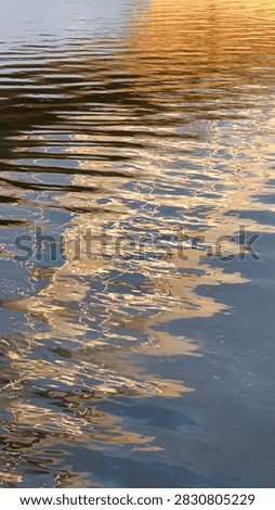 background of surface of Danube River with reflected sunlight and nightlights