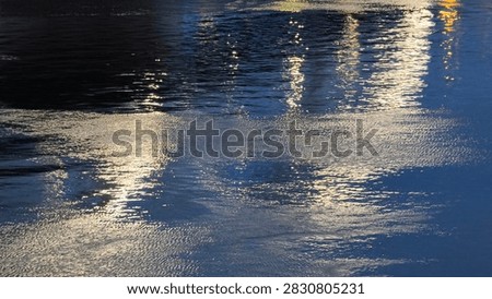 background of surface of Danube River with reflected sunlight and nightlights