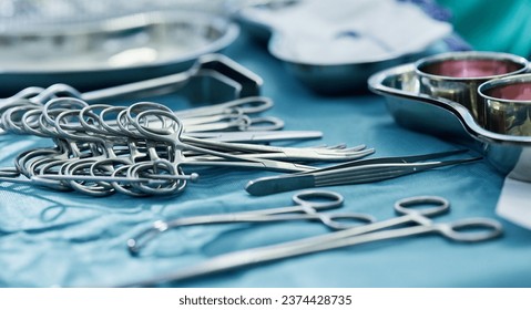 Background, surgery and metal tools in operating room for hospital assessment, healthcare service or emergency in medical theatre. Closeup, surgical equipment and scissors with forceps for operation