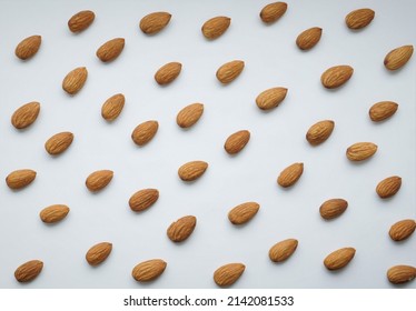background texture of almond nuts on a white background.