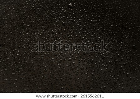 background texture for black background with shimmering elements and flowing drops on glass, with overflows and bokeh, beautiful bright background with overflows and gradient