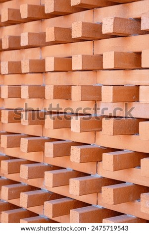 Background and Texture of Brick blocks or Red terracotta bricks. Beautifully arranged together with sunlight hitting them, creating an image dimension for the exterior building is modern architecture.