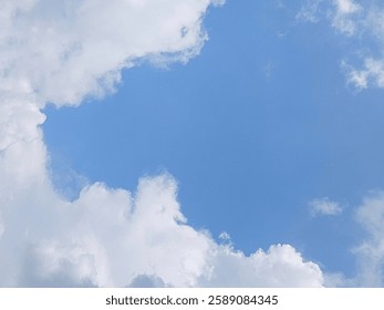 Background texture of bright blue sky covered with cumulus clouds, beautiful and aesthetic cloud scene. Soft white clouds floated in the blue sky that looked like soft cotton floating in the air.