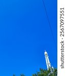 The background and texture of the clean blue sky, decorated with white mosque tower domes and green trees