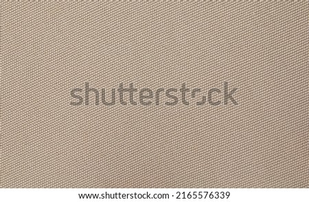 Background texture of coarse woven brown fabric.