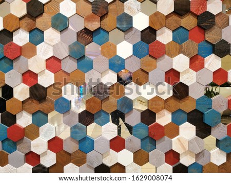 Background texture colorful hexagon shape and pattern of multicolor wooden honeycomb section for decorate wall, ceiling, wallpaper. In light and dark brown, red, blue, black with real wood style.