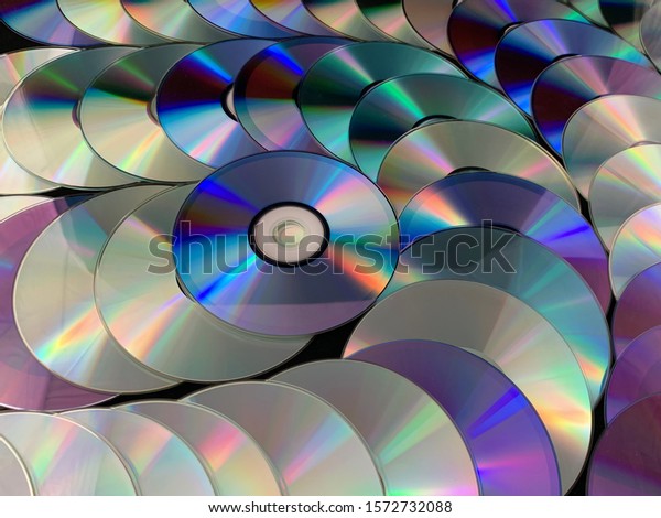 Background texture: a lot of computer disks.\
Music CDs on a black background, abstraction. Concept: melody,\
music, melomania,\
nastalgia.