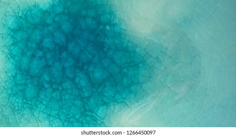 background texture of cooling cracked on ceramic surface green color, beautiful glazing cracked under surface, turquoise broken abstract background texture, pottery vintage design texture blue color