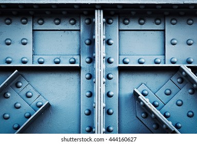 background or texture detail blue silver riveted girder railway bridge