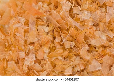 Background texture of dried, shredded bonito flakes.