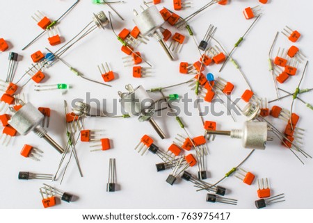 Background texture of electronic components. Resistors, diodes, transistors on a light background