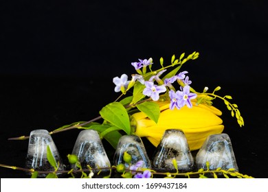 Background Texture Iced ,water With Purple Flower, Yellow Flowers Ylang Ylang Arrangement Postcard Style On Black