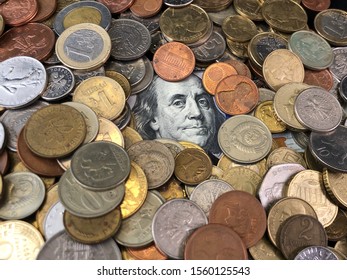 Background texture: iron money from different countries. Banknote with the image of Benjamin Franklin and a stack of coins. A collection of metal money, on a black background. Dollar reliability.