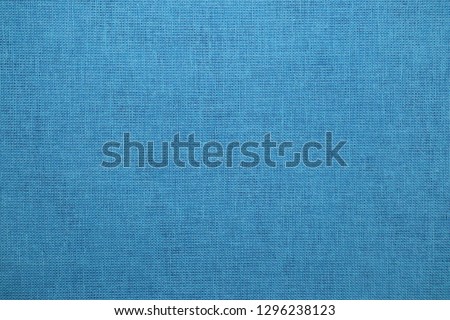 Background texture of light blue fabric close-up
