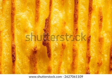 A background with the texture of mashed potatoes baked until golden brown in the oven. Close-up, macro photography. Use for menu and banner. High quality photo