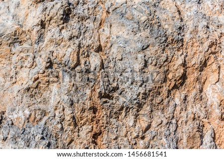 background and texture of mountain layers and cracks in sedimentary rock on cliff face. Cliff of rock mountain. 
