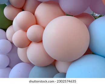 Background texture: Multicolored inflatable balls. Lots of balloons of different sizes. Festive background of gel balloons.