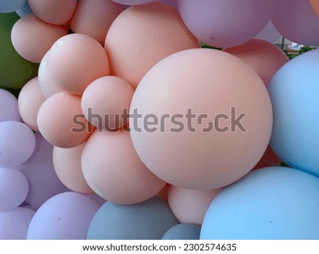 Background texture: Multicolored inflatable balls. Lots of balloons of different sizes. Festive background of gel balloons.